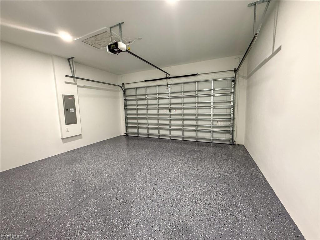 Garage with electric panel and a garage door opener