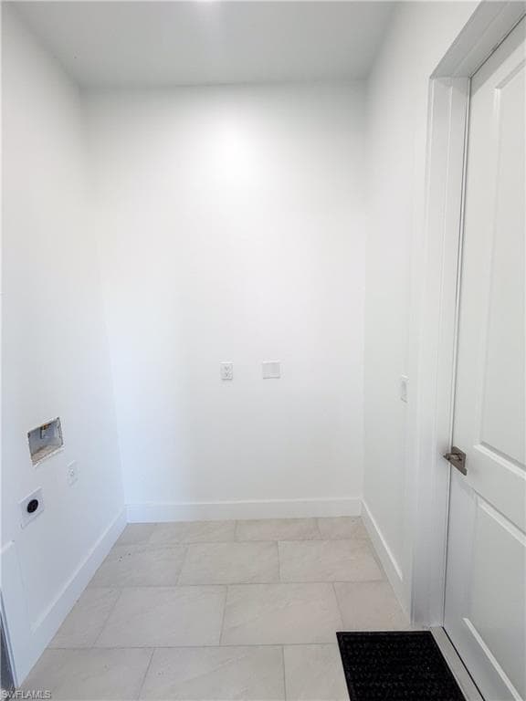 Laundry room featuring hookup for an electric dryer and light tile patterned floors