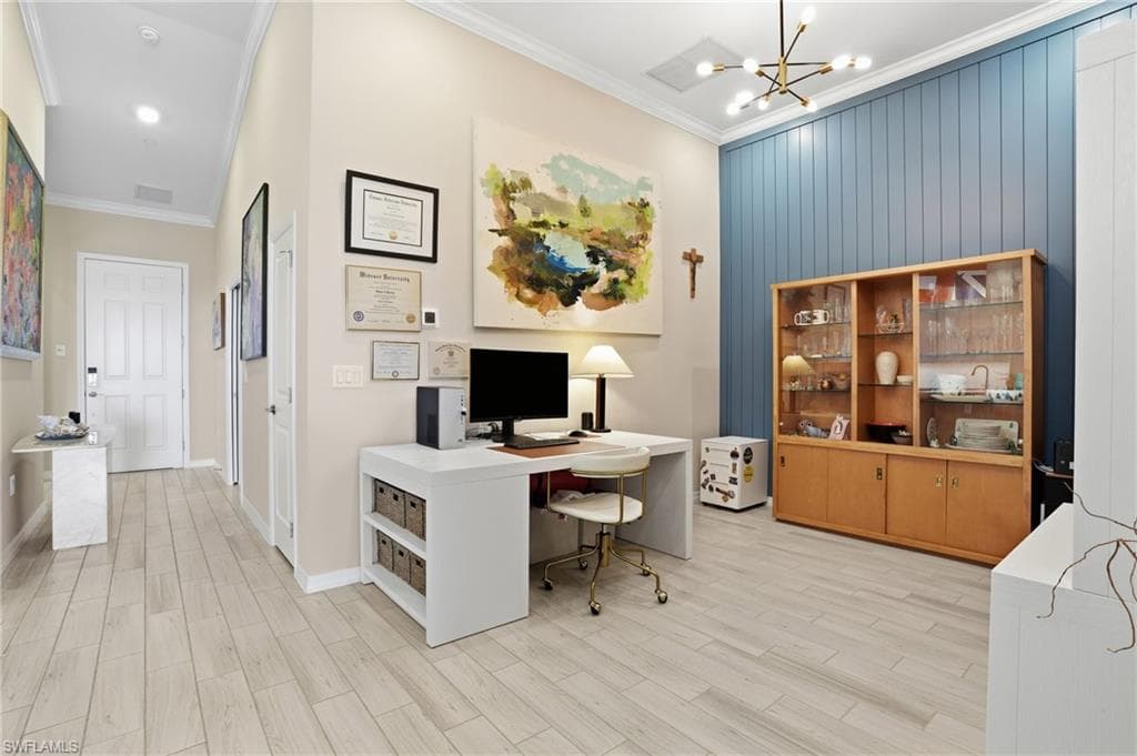 Office featuring crown molding, wood finish floors, and suspended lighting