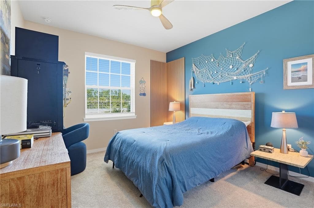 Bedroom with light carpet and ceiling fan