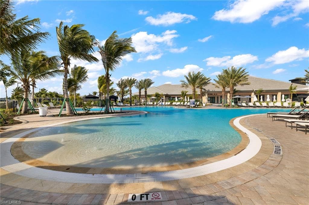 Community pool with a patio