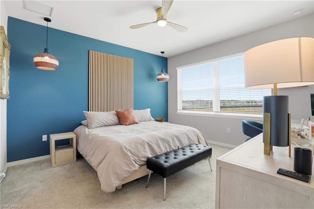 Bedroom featuring light carpet and ceiling fan