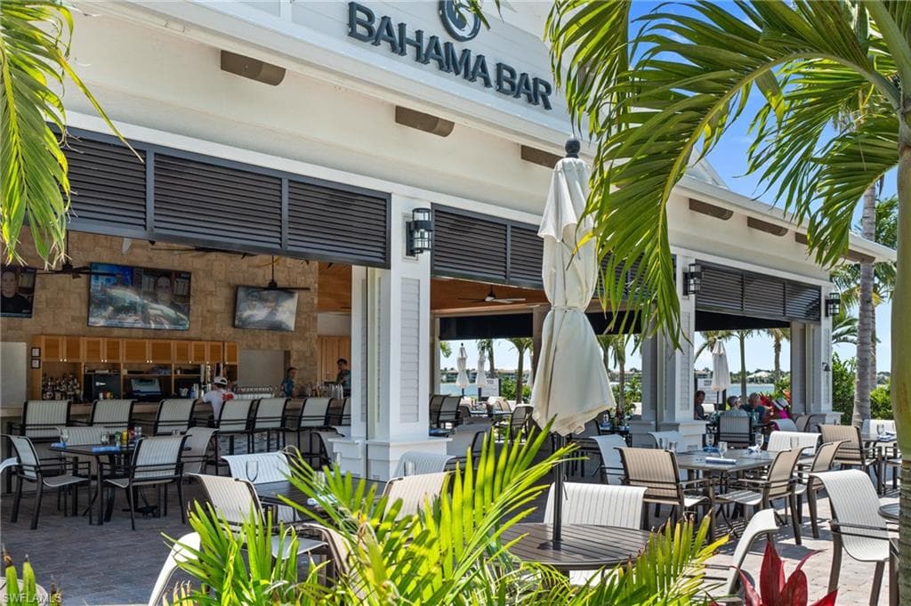 View of patio with outdoor dining area and ceiling fan