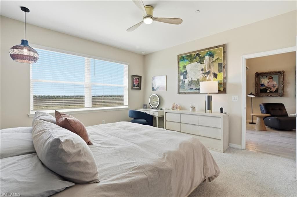 Bedroom featuring light carpet and a ceiling fan