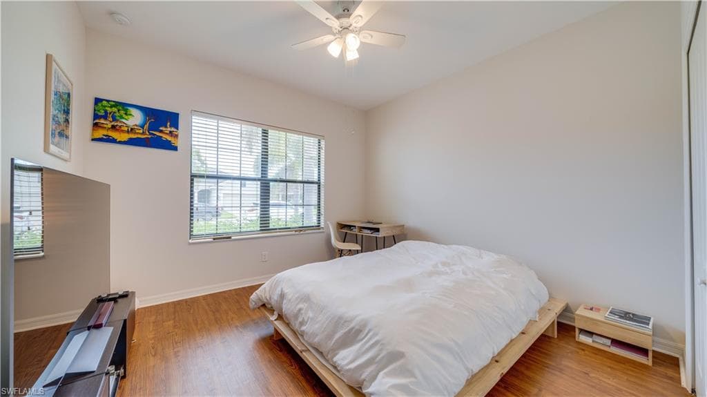 Bedroom with wood finished floors and ceiling fan
