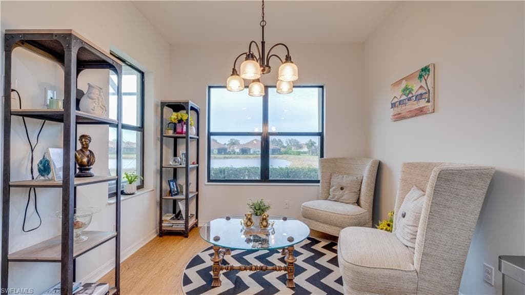 Living area featuring hanging lights and light wood-style floors