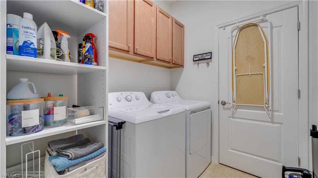 Laundry room with cabinet space and washing machine and clothes dryer