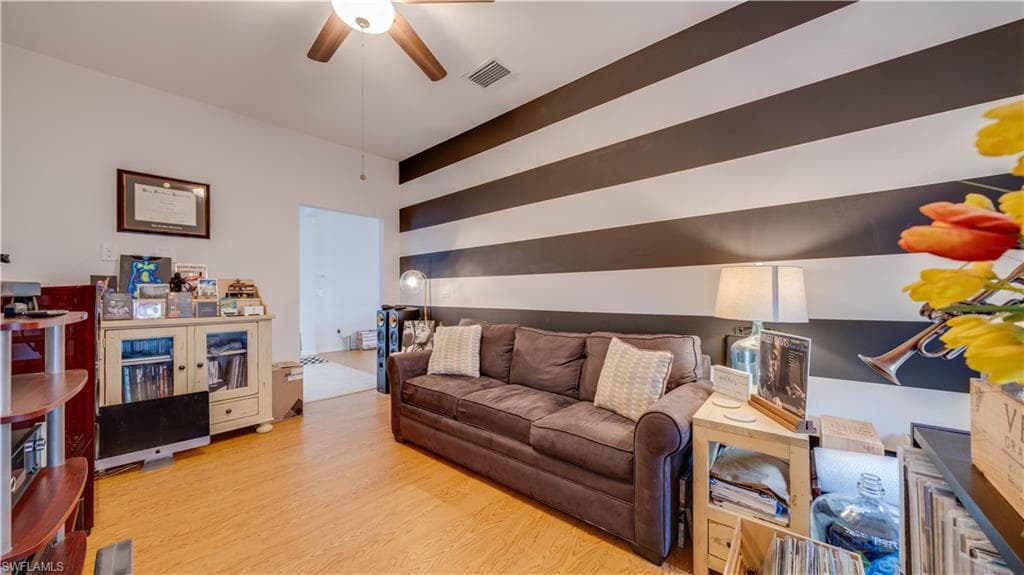 Living room featuring light wood finished floors and ceiling fan