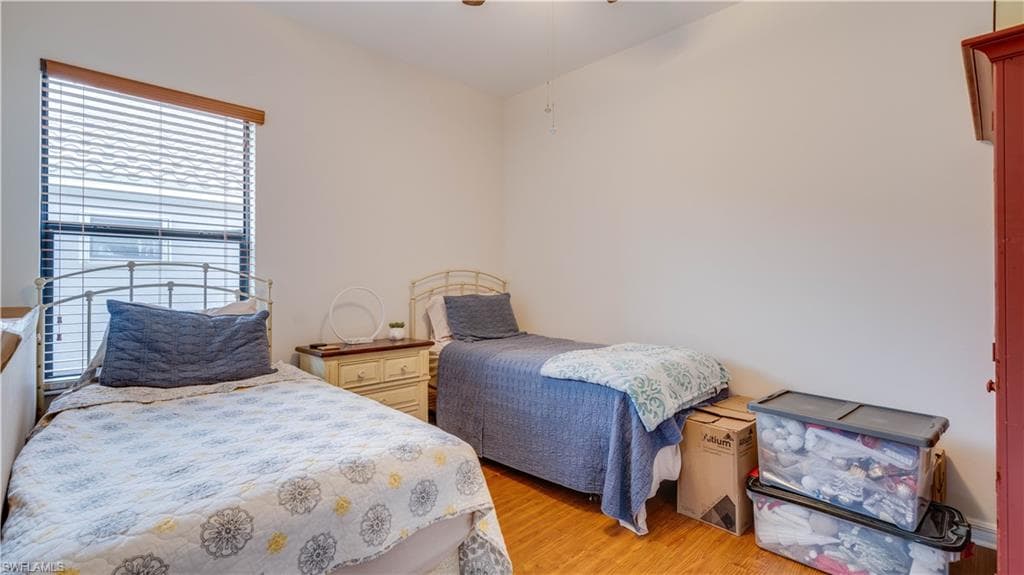 Bedroom with light wood finished floors and a ceiling fan