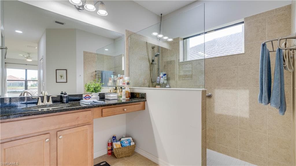 Full bath with vanity and a walk in shower