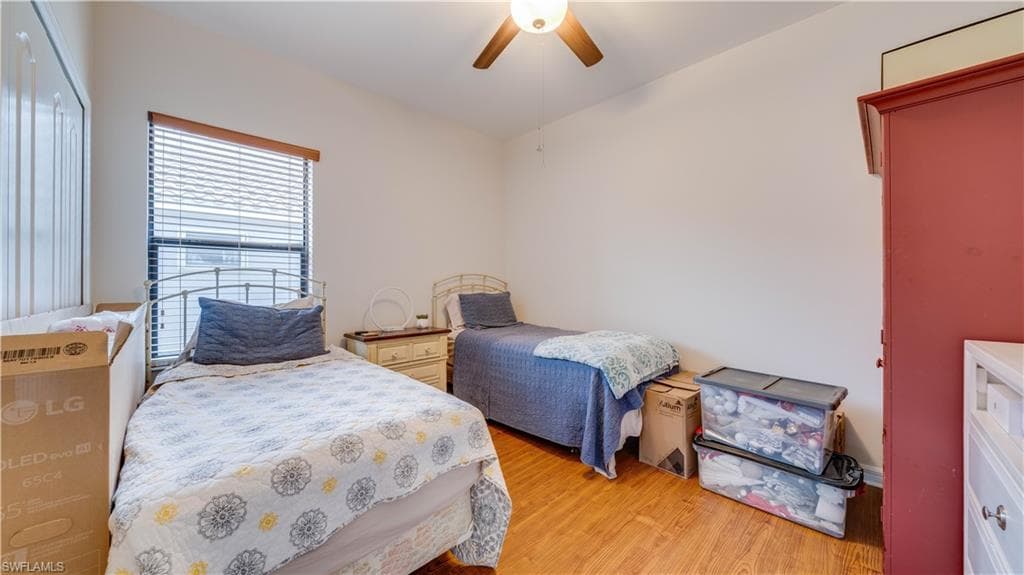 Bedroom featuring light wood-style flooring and a ceiling fan