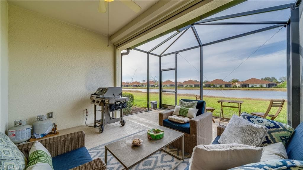 Sunroom featuring outdoor furniture, a residential view, and a patio