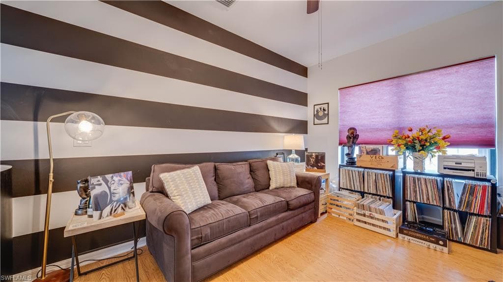 Living room featuring light wood-type flooring and ceiling fan
