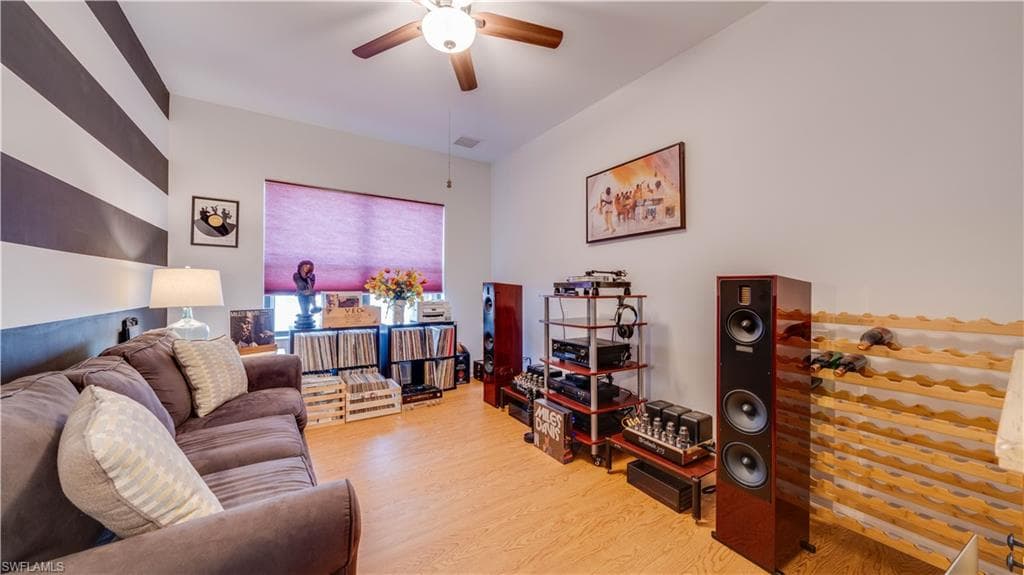 Living area with wood finished floors and ceiling fan