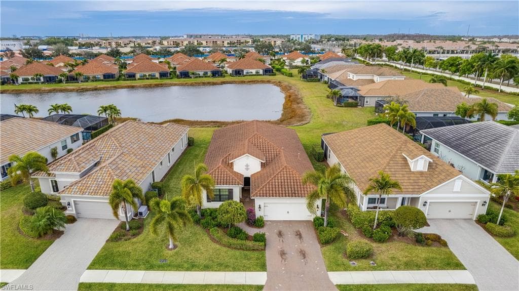 Aerial perspective of suburban area featuring a large body of water