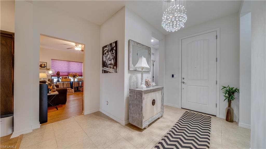 Entryway with suspended lighting, light tile patterned flooring, and ceiling fan