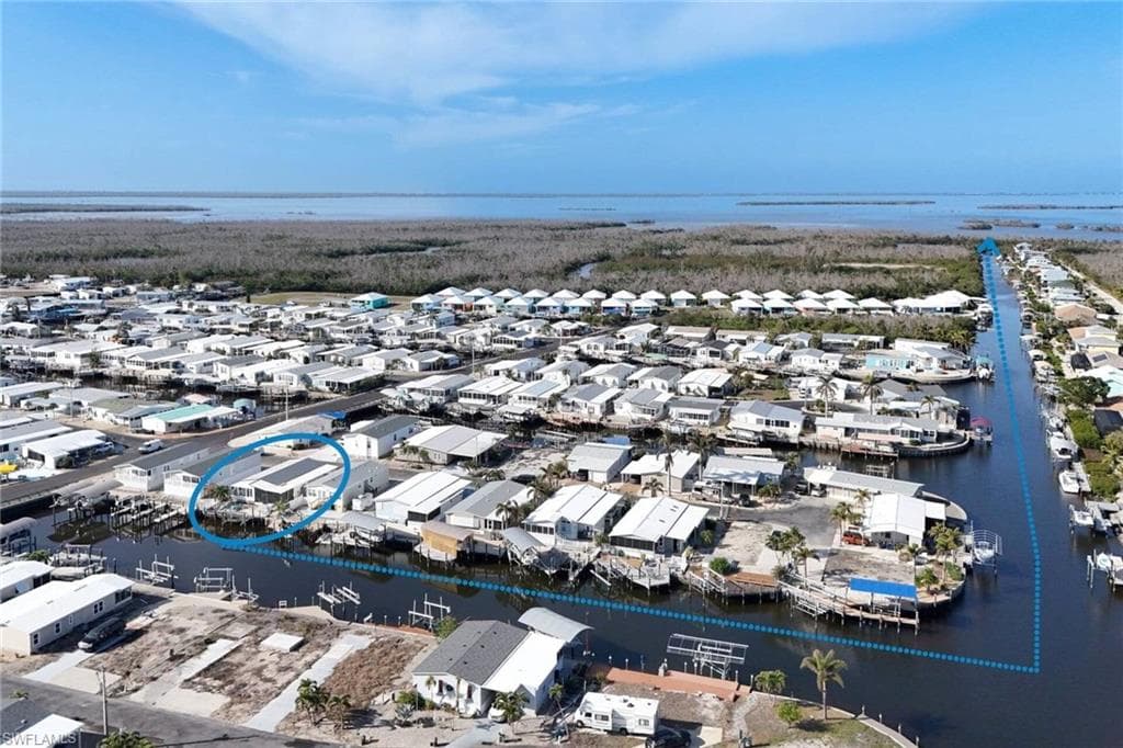 Aerial perspective of suburban area featuring a large body of water