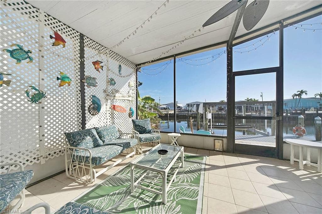 Sunroom / solarium featuring a water view and outdoor seating
