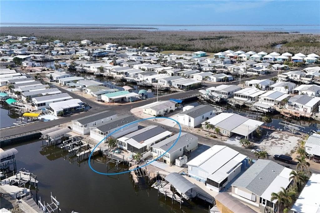 Aerial perspective of suburban area featuring a large body of water