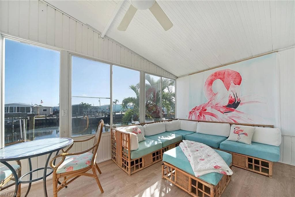 Sunroom featuring outdoor furniture, a ceiling fan, and lofted ceiling