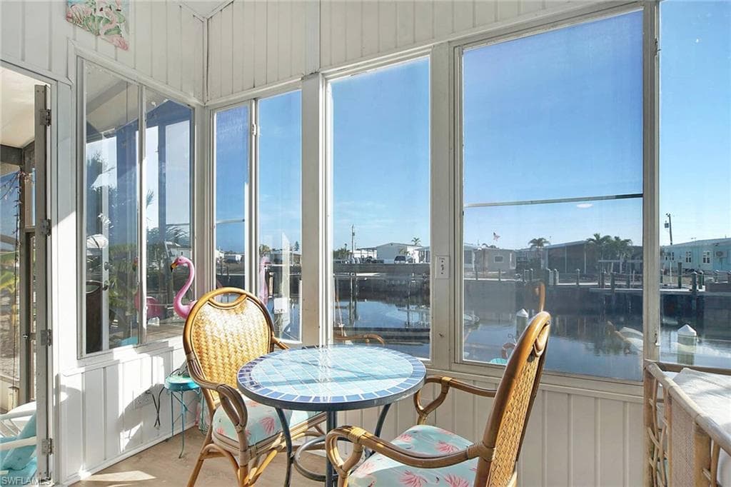 Sunroom / solarium with a water view