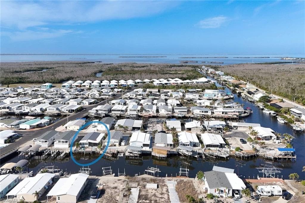Aerial perspective of suburban area featuring a large body of water