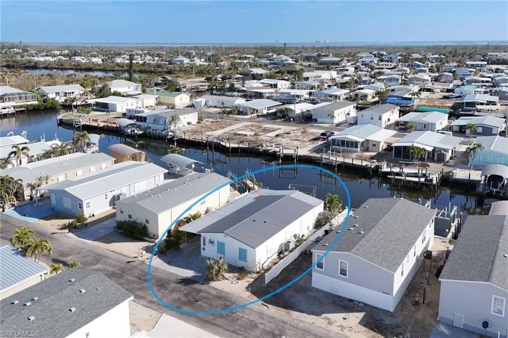 Aerial view of residential area featuring a nearby body of water