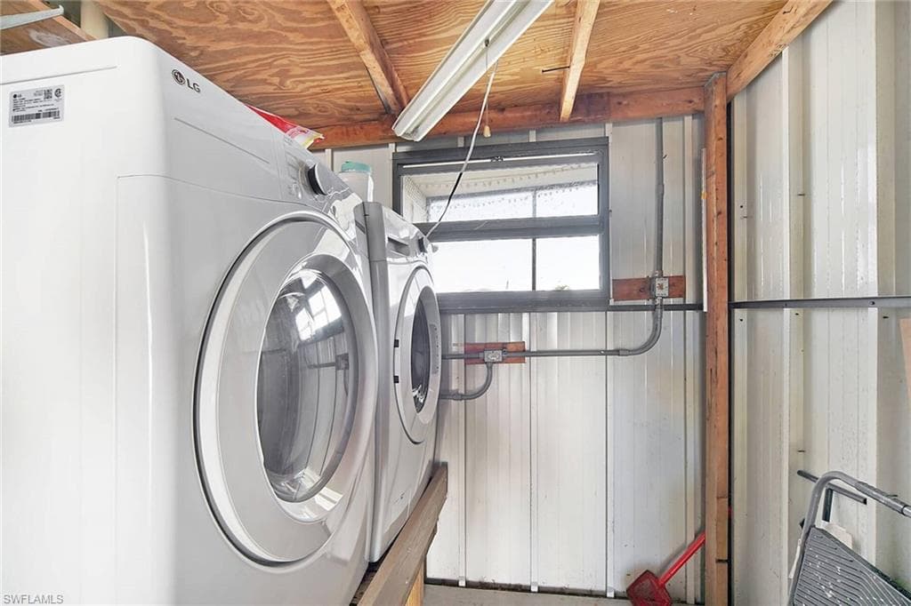 Laundry room with washing machine and clothes dryer