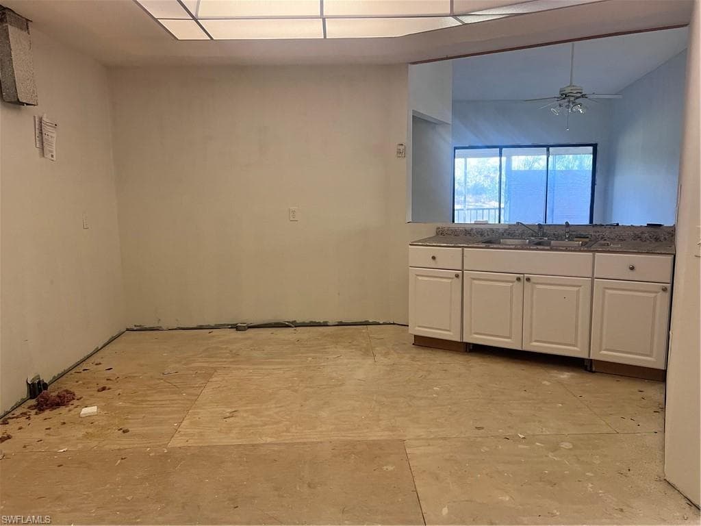Kitchen with white cabinetry and ceiling fan