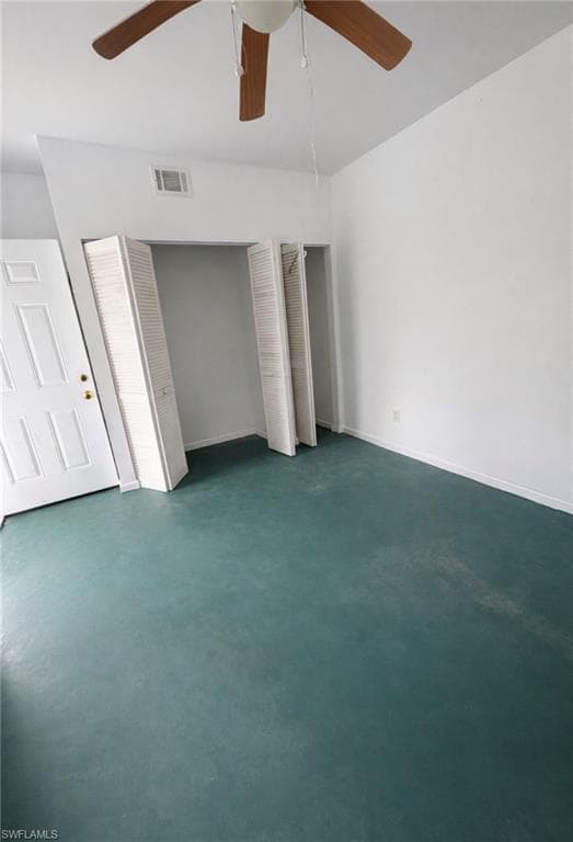 Unfurnished bedroom featuring multiple closets and a ceiling fan