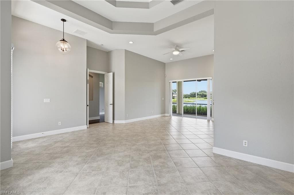 Spacious interior with neutral wall tones and large format tile flooring