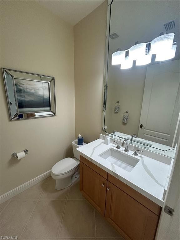 Half bath featuring vanity and light tile patterned floors