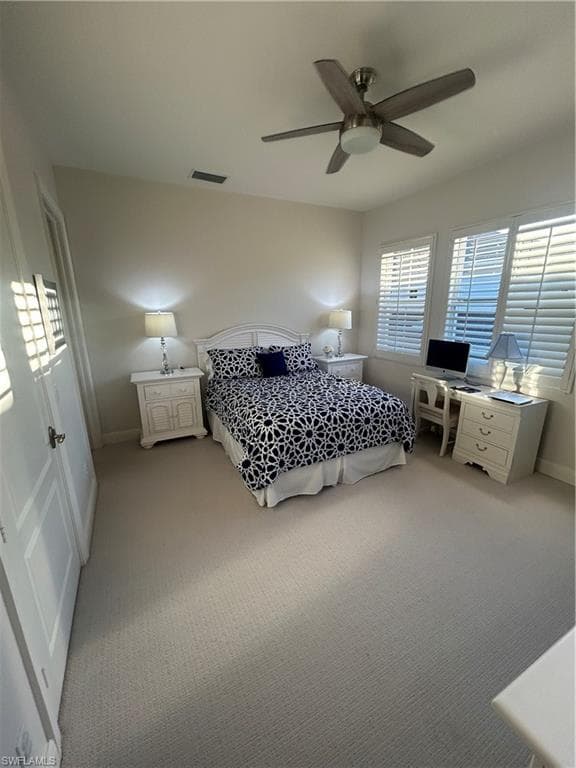 Bedroom with light colored carpet and ceiling fan