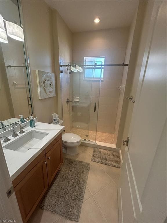 Bathroom with vanity, a shower stall, light tile patterned floors, and recessed lighting