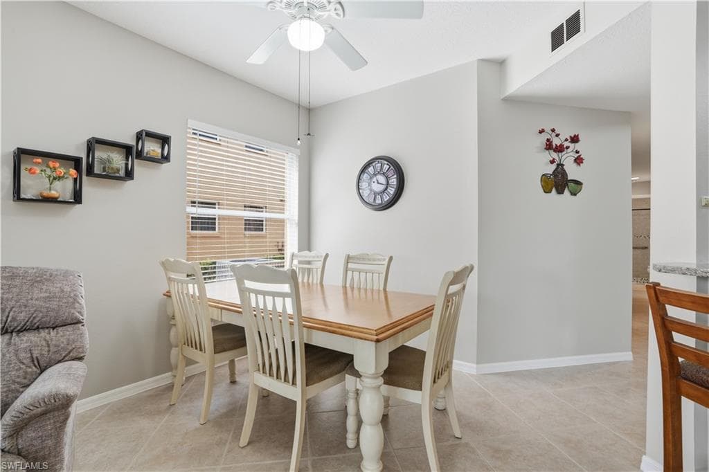 Dining space featuring ceiling fan and light tile patterned floors