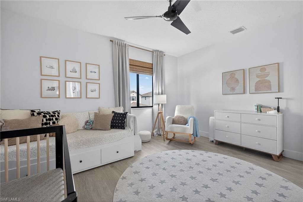 Bedroom featuring light wood-style flooring and a ceiling fan