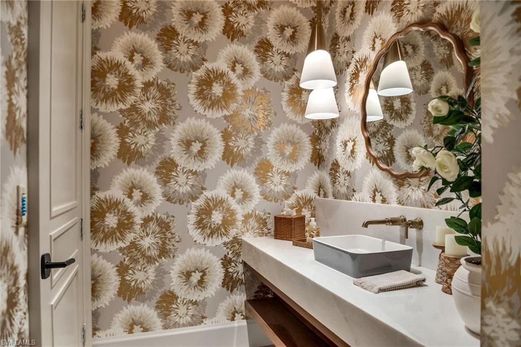 Stunning powder bath with Philip Gorrivan wallpaper and a high lacquer gloss ceiling