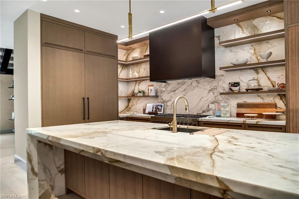 Kitchen, angle 2, highlighting the Wolfe gas range, copper hood, and integrated Subzero fridge and freezer