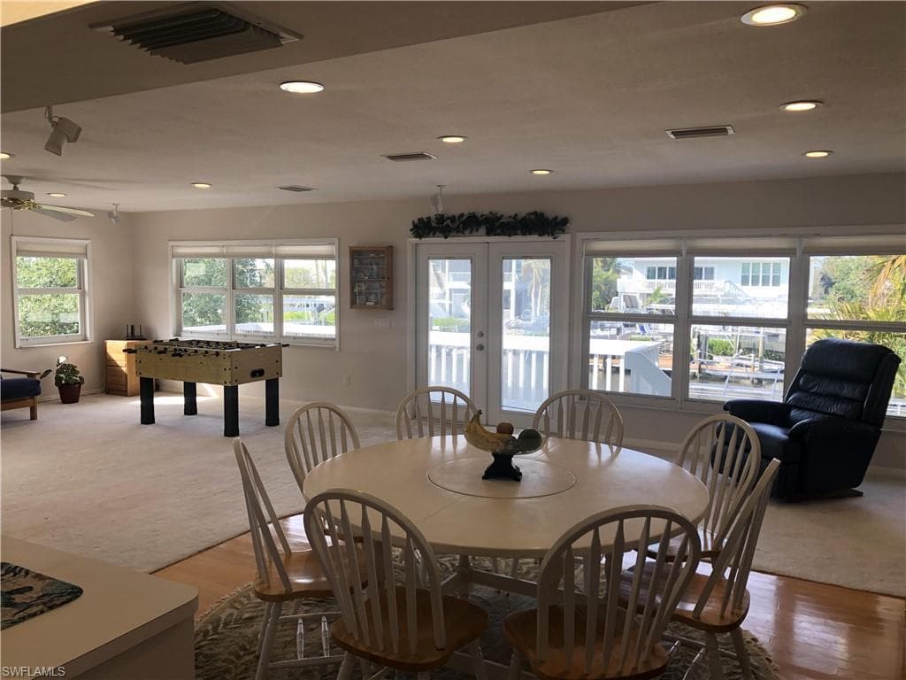 Carpeted dining space featuring recessed lighting, wood finished floors, and a ceiling fan