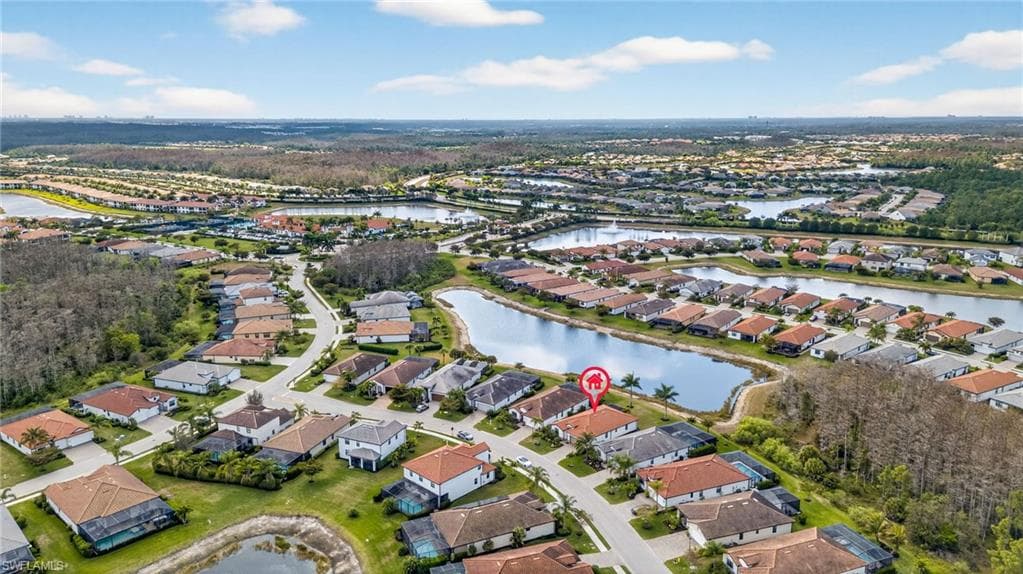 Aerial view of property's location with nearby suburban area and a large body of water