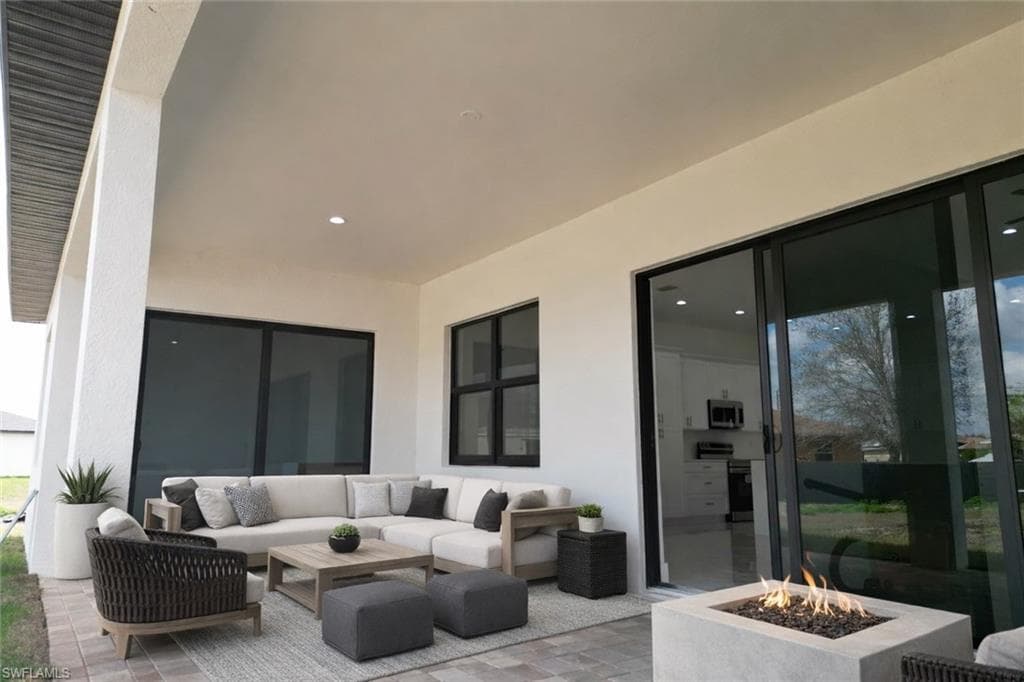 View of patio / terrace featuring an outdoor living space with a fire pit