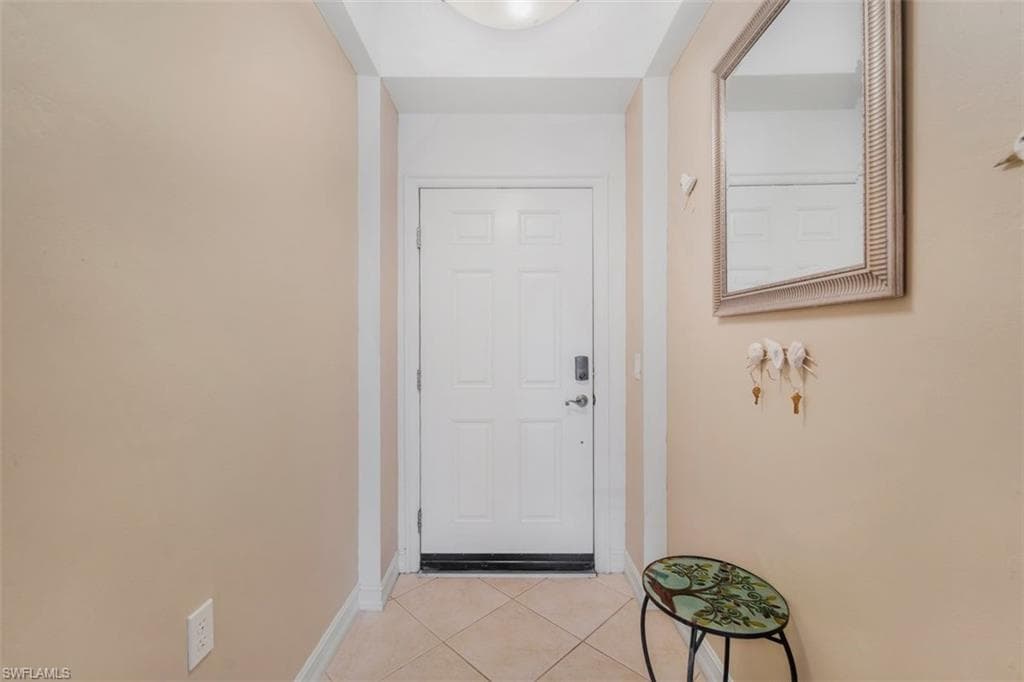 Entryway featuring tile patterned flooring and baseboards