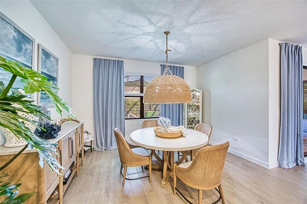 Dining area with light wood finished floors and baseboards