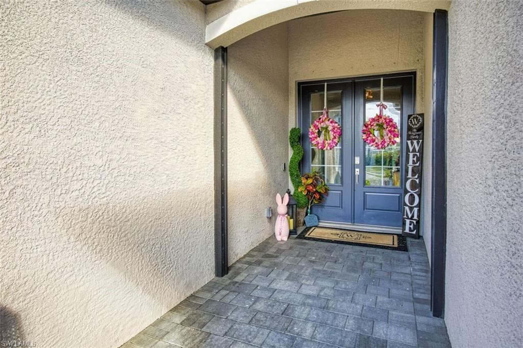 Doorway to property with french doors and stucco siding