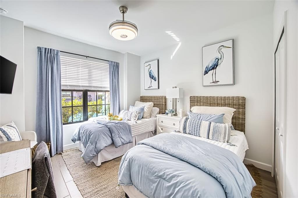 Bedroom with baseboards and wood finished floors