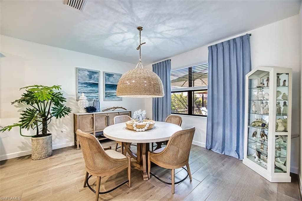 Dining area featuring light wood finished floors and baseboards