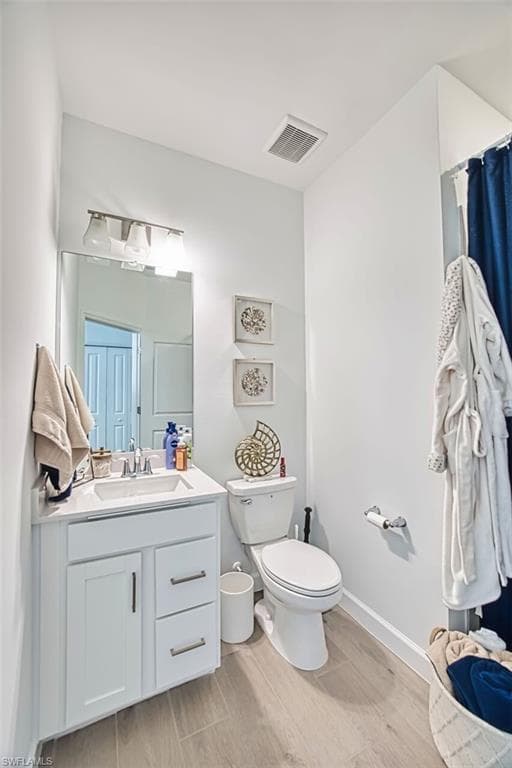 Bathroom featuring vanity and wood finish floors