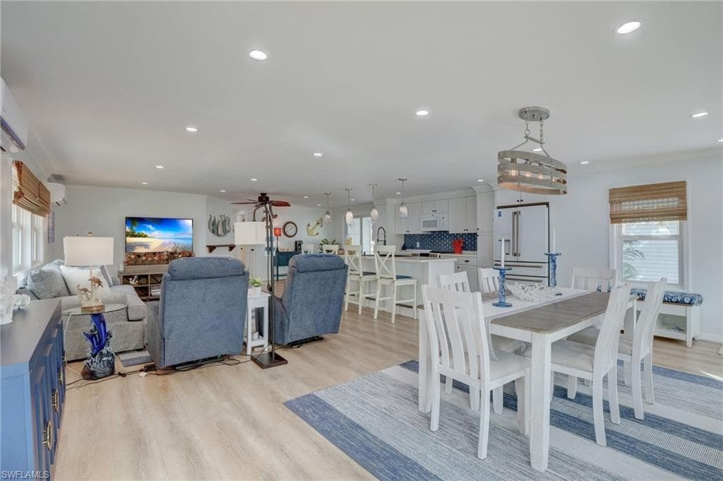 Dining room featuring plenty of natural light, light wood-type flooring, recessed lighting, and ceiling fan