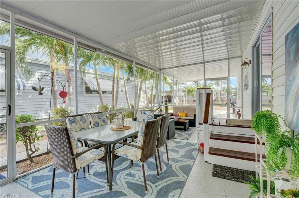 Sunroom with an outdoor living / dining area and healthy amount of natural light