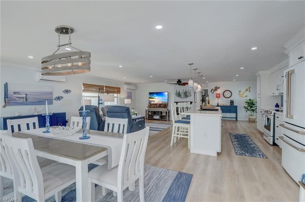 Dining area featuring light wood finished floors, recessed lighting, and ceiling fan
